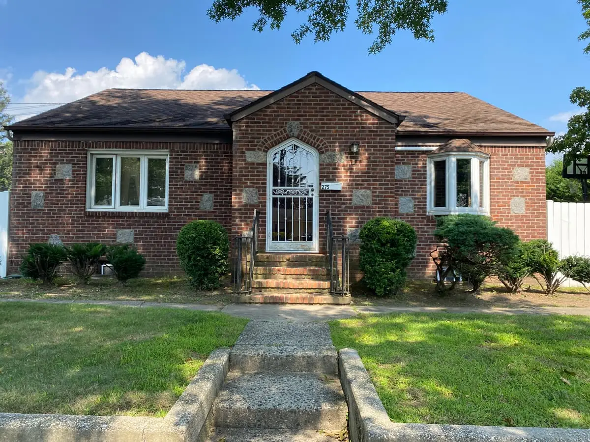 Trying to stop a foreclosure in Plainview: brick ranch with an arched front door and brick steps