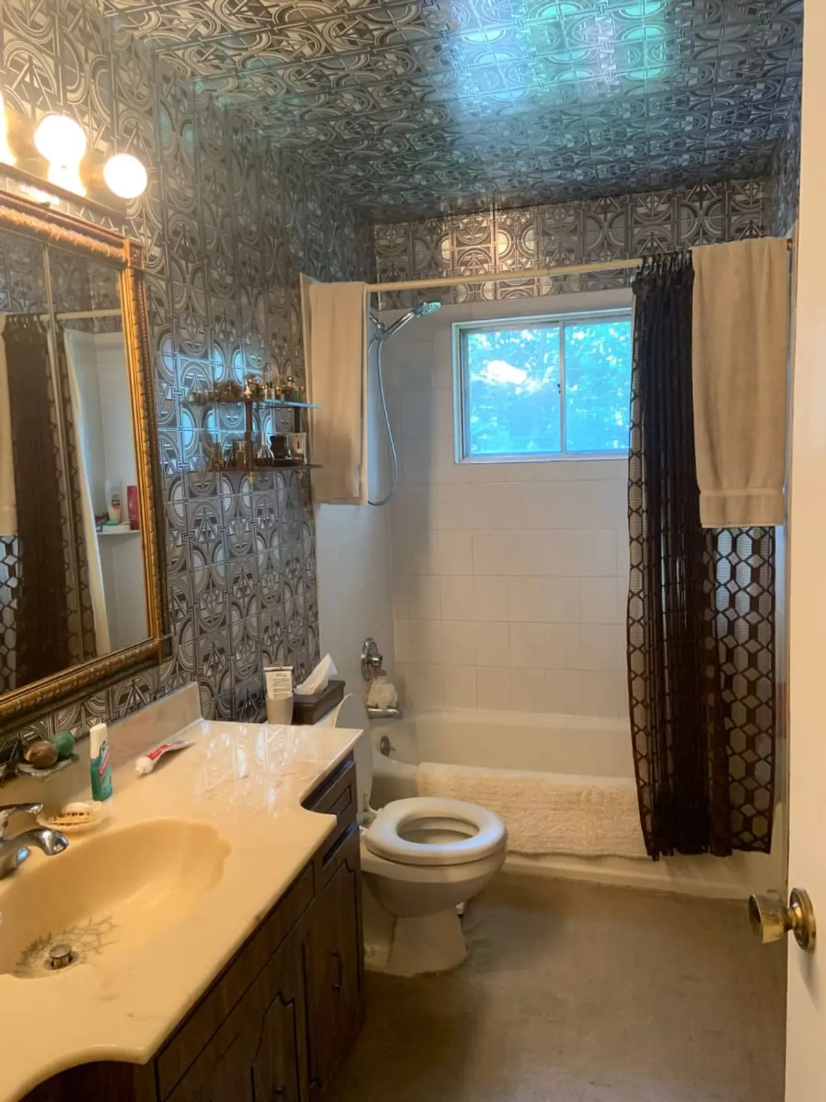 Selling a house with multiple heirs in Plainview: dated bathroom with metallic patterned wallpaper