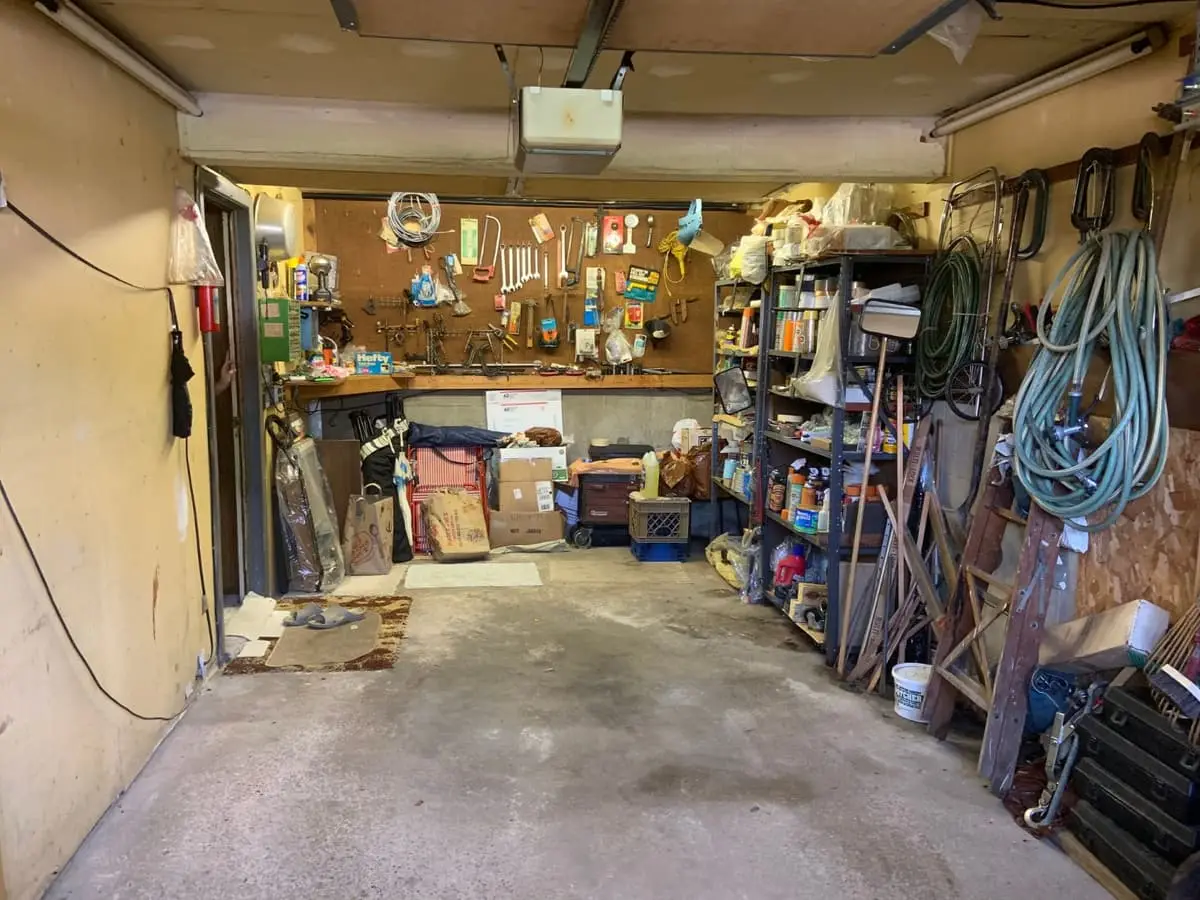 Selling in the Plainview housing market: garage lined with tools, hoses and shelving