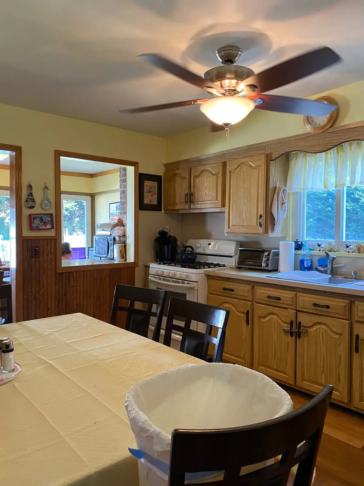 Wondering what your Plainview house is worth: occupied eat-in kitchen with oak cabinets and a ceiling fan