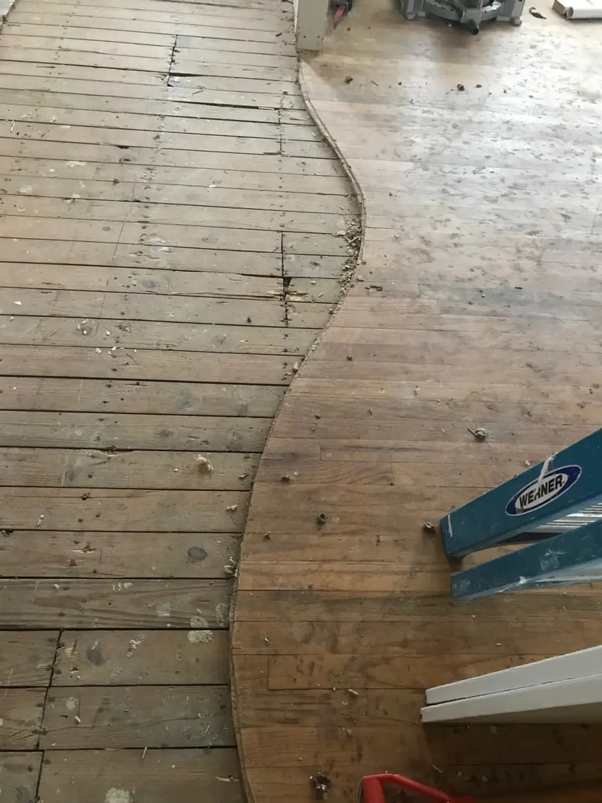 Selling a fire-damaged house in Plainview: subfloor exposed where the old flooring was pulled up